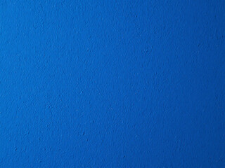 Close up of a textured royal blue surface with a rough and bumpy