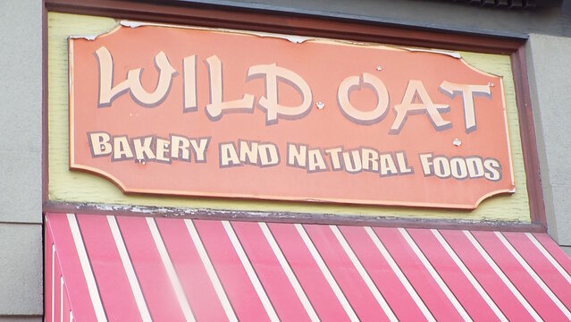 Ottawa, ON, Canada-May 25,2025: The storefront sign for "Wild Oat Bakery and Natural Foods"  at 817 Bank Street.
