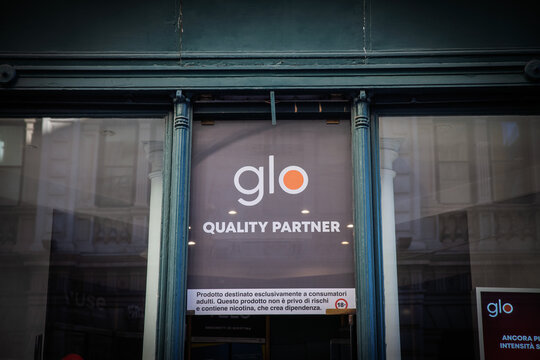 TRIESTE, ITALY - DECEMBER 17, 2024: Glo logo in front of a local shop in Trieste, Italy. Glo, beloning to British American Tobacco is a tobacco heating cigarette system