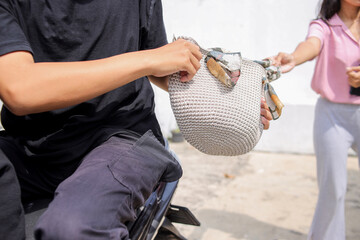 Close Up Of Hands Struggling Over Crocheted Purse