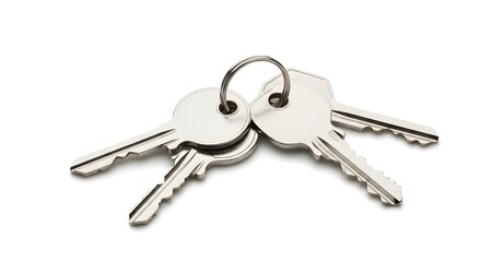 Stock photo of silver metal house keys on keyring isolated on white background for security concept use
