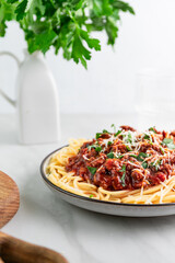 Pasta spaghetti with beef traditional bolognese sauce on white table