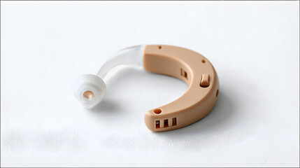close-up shot of a beige hearing aid, designed to enhance auditory perception