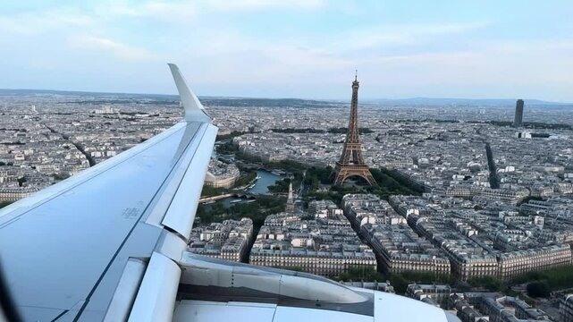 Cinematic Aerial View from Airplane Window Over Paris &ndash; Eiffel Tower, Haussmannian Architecture, and La D&eacute;fense Under Golden Sky Captured in Reflective Travel Animation of Urban Beauty

