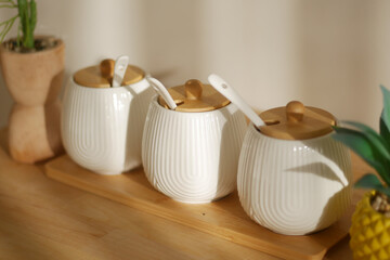 Ceramic jars with wooden lids on a wooden display board