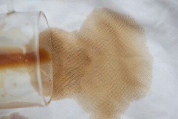 Coffee spills on white cloth surface in kitchen setting