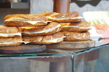Freshly made sesame bagels neatly arranged on a display