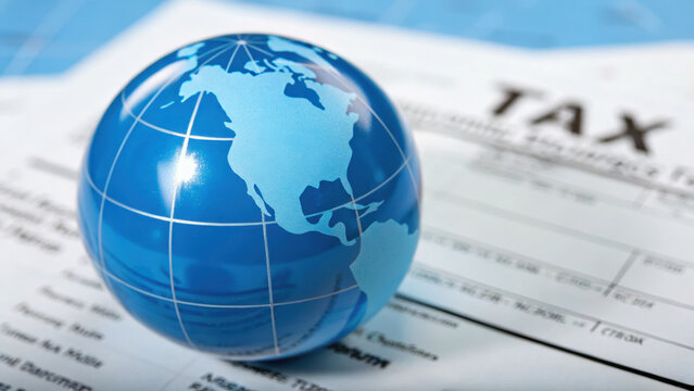 Close-up of globe with overlay of tax document, symbolizing international tax deal compliance, global economic regulation, and cross-border financial governance concepts