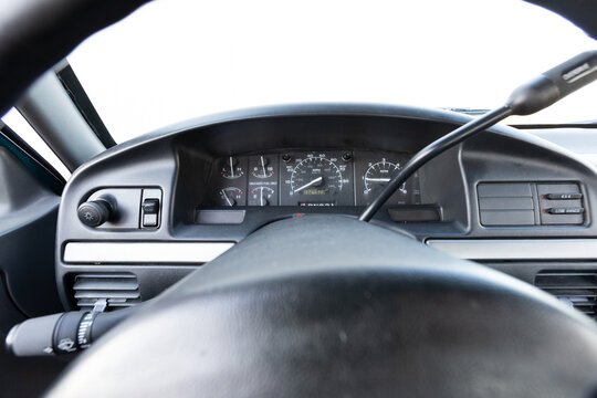 Close-up dashboard details of an older American pickup truck with 4x4 drivetrain. Features include control knobs, radio unit, climate panel, and gauges, all photographed in clean daylight conditions