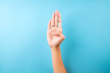 Female Hand Showing Letter B In Sign Language Isolated On Blue Background © Queenmoonlite Studio