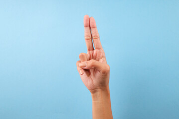 Finger Spelling Letter U In American Sign Language Isolated On Blue Background