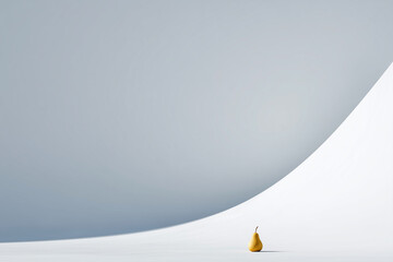A pear is sitting on a snowy hill. The hill is very steep and the sky is cloudy