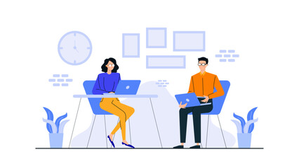 Man and woman working on laptops in a room with a clock