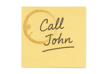 Yellow sticky note with handwritten reminder for john, coffee cup stain visible, resting on transparent background
