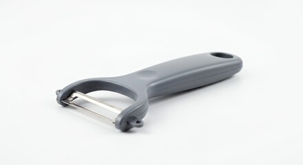 Obraz premium Gray vegetable peeler on white background