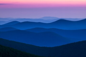 Fototapeta premium Blue mountain ranges at sunset glow