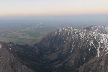 Mountain range against clear sky and plains
