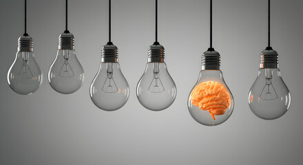 Orange Brain Inside Lit Light Bulb Among Dull Bulbs on Gray Background