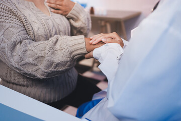 Fototapeta premium Medicine doctor hand reassuring her female patient