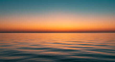 Obraz premium Serene Sunset over Calm Ocean Waters Vibrant Orange and Teal Sky at Dusk
