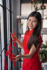Beautiful young asian woman red clothes making paper craft red Chinese new year lantern for Lunar New Year decorations Chinese New Year Celebrations for good luck © Charlie's
