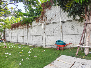 a yard with a lawn chair and a wall