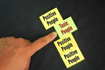 Colored paper with the words Toxic People vs. Positive People. the concept of good employee selection. positive and negative people. Avoid toxic person concept