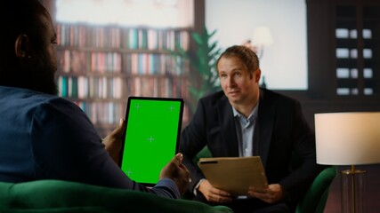 Multiethnic secret agents discussing next to isolated mockup on display, meeting in the CIA bureau to discuss important mission details. Secure information and professional camaraderie. Camera A.