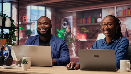 African American couple at their home office collaborate on a project, using teamwork and digital...