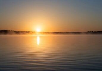 Golden Sunrise Over Misty Lake
