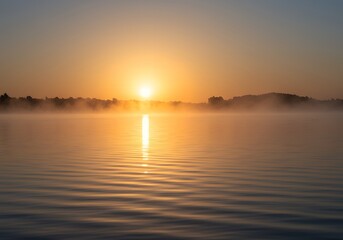 Obraz premium Misty Sunrise over Calm Lake