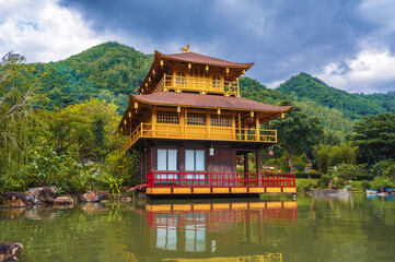 Fototapeta premium Beautiful Asian Buddhist Temple on water on the lake at Vietnamese Nghia Son Pagoda in mountains in Nha Trang in Vietnam in Asia