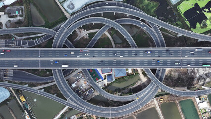 Multi-level overpass China. Lot cars drive on transportation interchange. Road traffic. Chinese economy. Aerial top drone above view of fast urban highway. Modern city freeway. Busy auto express way.