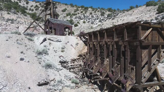 Horn Mine near Milford, Utah. Shot of the ore hopper bins that then rises to show the machinery shop and the head frame.