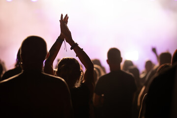 Crowd at concert and blurred stage lights.