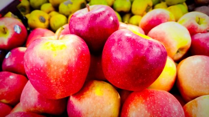 Close-up view of glossy red apples for sale at supermarket
