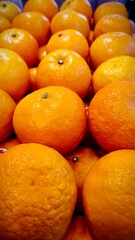 a collection of oranges in a basket on display in a supermarket