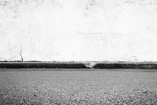 Fototapeta Gray concrete wall and asphalt