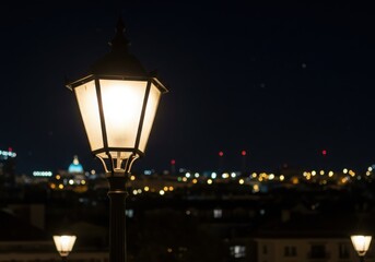 Illuminated street lamp with city lights at night