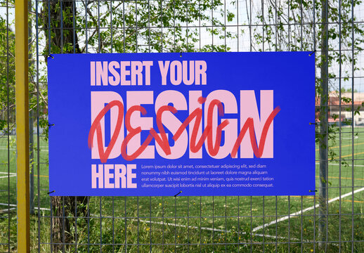 White mockup template info panel displayed on a fence near a sports field.