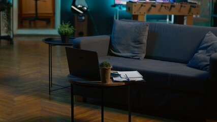 Modern apartment loft with a cozy corner and trendy furniture, comfy space decorated with electronics and a coffee table. Empty studio living room with minimalist decor, chill lifestyle.