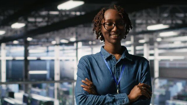 Portrait of smiling data center admin next to coworkers running diagnostics on equipment to identify errors. Happy woman next to IT experts working to prevent failure and minimize downtime, camera B - Powered by Adobe