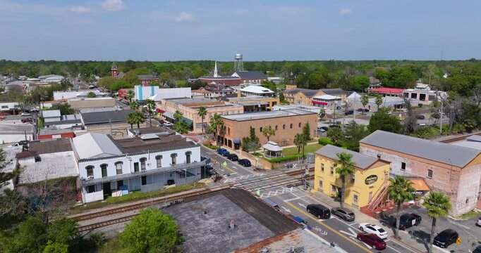 Main street intersection with slow traffic and old historical architecture in small town America. Southern low buildings in Starke, Florida.