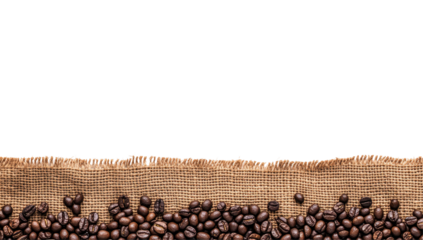 Roasted coffee beans scattered on burlap against a black background
