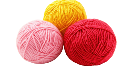 Three balls of yarn in pink, yellow, and red, arranged in a triangular formation against a black background