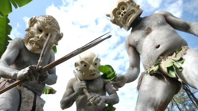 Asaro Mudmen tribe bow hunting. Papuan tribe dance. Mount Hagen tribe festival. Cultural event. Indigenous men in native costumes. High quality 4k footage