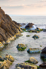 black sea nature in summer. travel background with calm water an rock on the beach in morning light. beautiful seascape