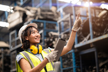 Happy Black Asian women technician engineer hardware stock warehouse worker enjoy working in heavy industry.