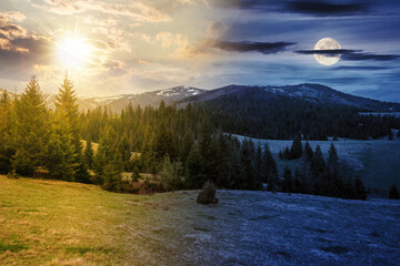 day and night time change concept. countryside landscape with forested hill and snow capped mountain range in the distance. nature scenery on spring equinox. cloudy sky with sun and moon