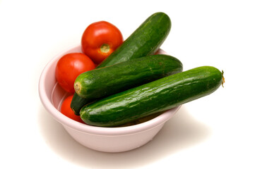 Fresh tomatoes and cucumbers in bowl ready for salad